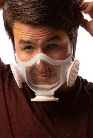 Handsome man putting on his OmniMask while looking at the camera.