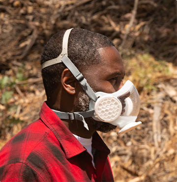 Profile of man wearing OmniMask in the outdoors.