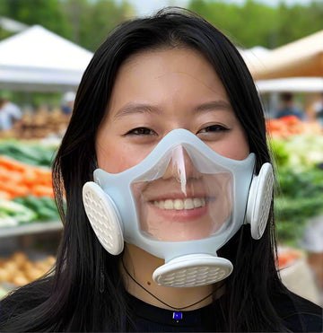 Young asian woman wearing OmniMask and smiling at friend.